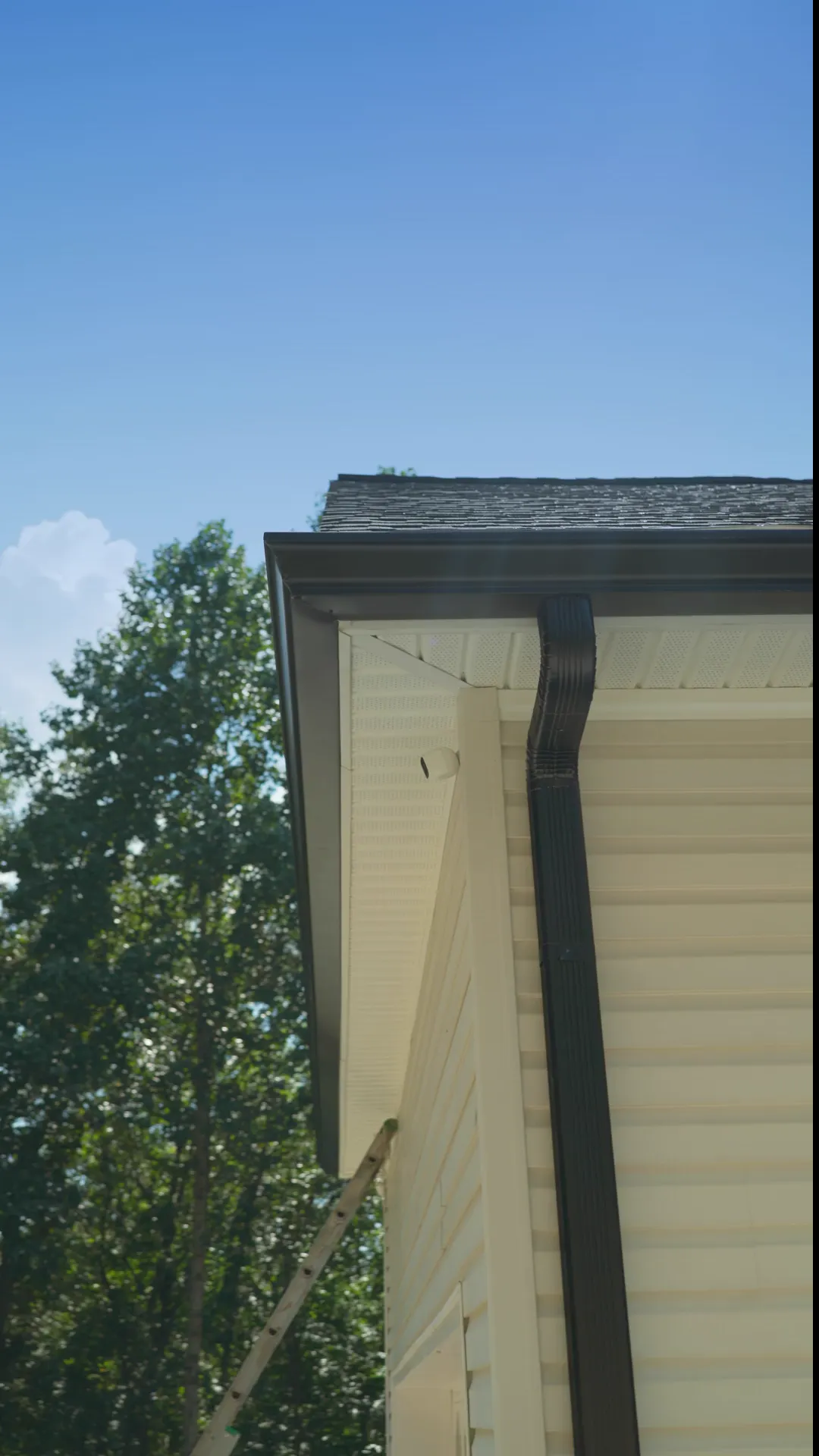Finished Gutter General gutters: a dark gutter and downspout, white gutters on red brick, and a copper downspout